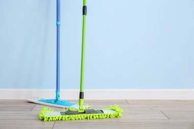 Floor mops near color wall