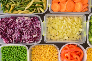 Plastic containers with different vegetables as background, closeup