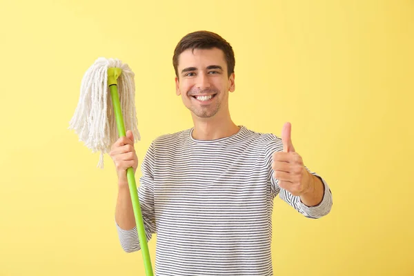 Young Man Floor Mop Showing Thumb Color Background — Stok fotoğraf