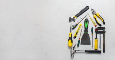House shape made with construction tools on light background with space for text