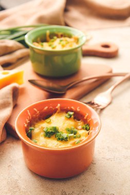 Ramekins with tasty julienne on light background