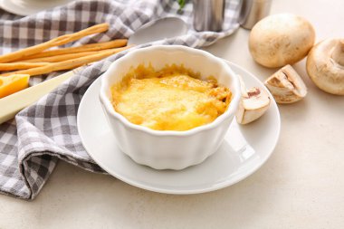 Ramekin with tasty julienne on light background, closeup
