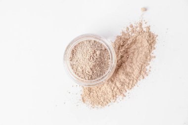 Jar with cosmetic clay on white background