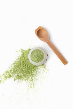 Jar and spoon with cosmetic clay on white background
