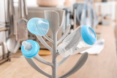 Drying rack for baby bottles on table at home, closeup