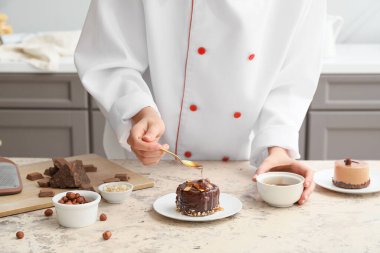 Woman cooking chocolate cake in kitchen