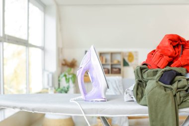 Electric iron with laundry at home