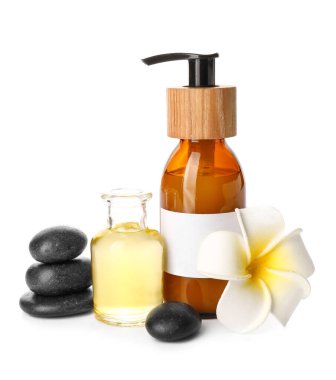 Composition with cosmetic products, spa stones and flower on white background
