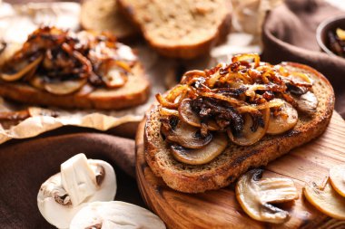 Tasty bruschetta with mushrooms, closeup
