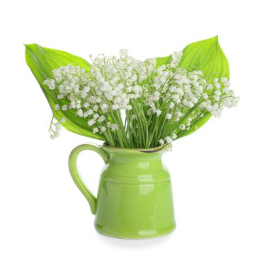 Jug with beautiful lily-of-the-valley flowers on white background
