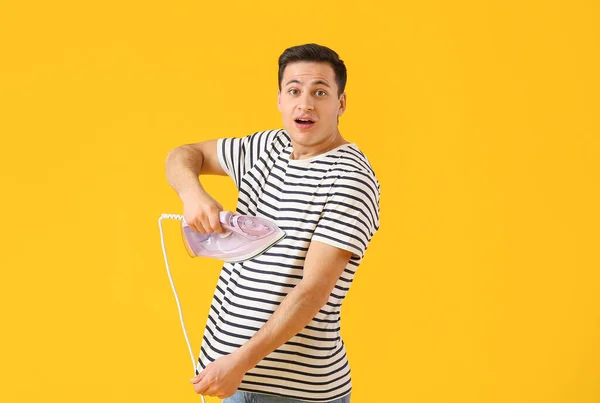 Handsome Young Man Ironing His Shirt Color Background — Fotografia de Stock