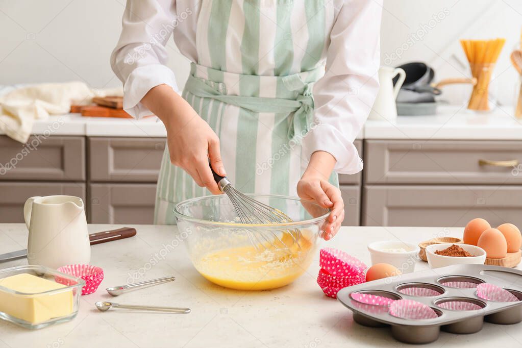 Woman preparing pastry in kitchen