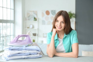 Evinde temiz çamaşırları olan güzel genç bir kadın.