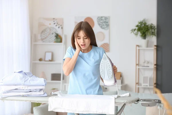Shocked Young Woman Ironing Laundry Home — Stock Photo, Image