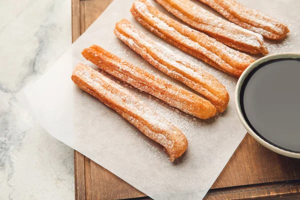 Board Tasty Churros Melted Chocolate Sauce Light Background Closeup — Stock Photo, Image