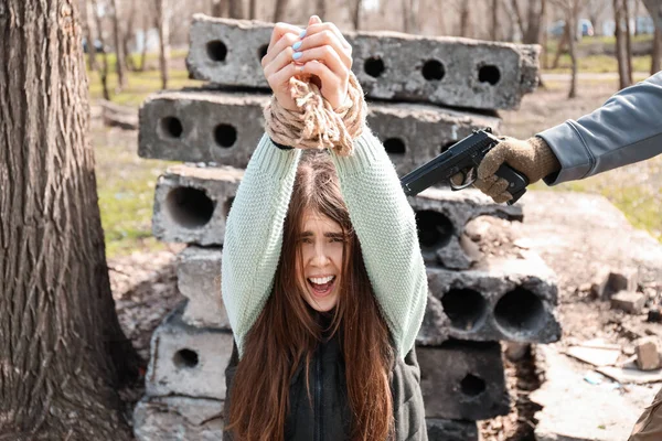 Terrorist Aiming Female Hostage Outdoors —  Fotos de Stock