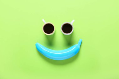 Renkli arka planda boyalı muz ve kahve fincanları ile yaratıcı kompozisyon