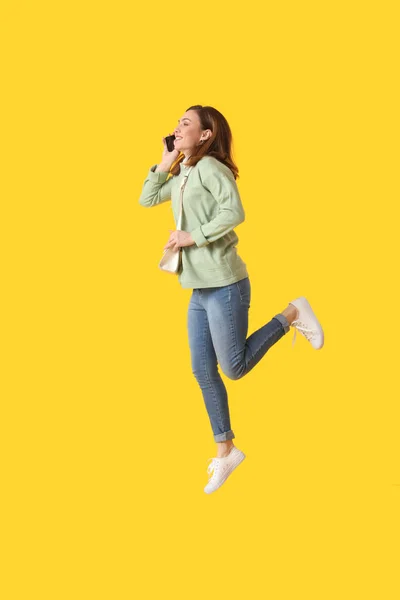 Jumping Young Woman Talking Mobile Phone Color Background — Stock Photo, Image