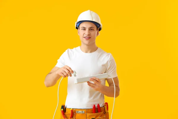 Young Electrician Outlet Color Background — Stock Photo, Image