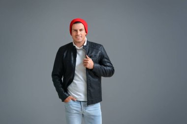 Gri arka planda şık bir genç adam.