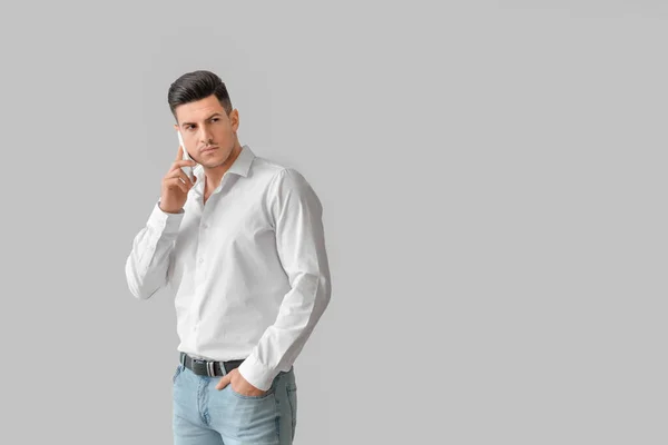 Fashionable Young Man Talking Phone Grey Background — Stock Photo, Image