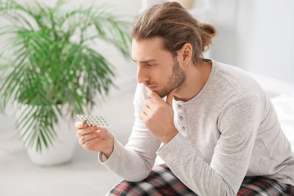 Thinking Young Man Pills Home — Stock Photo, Image