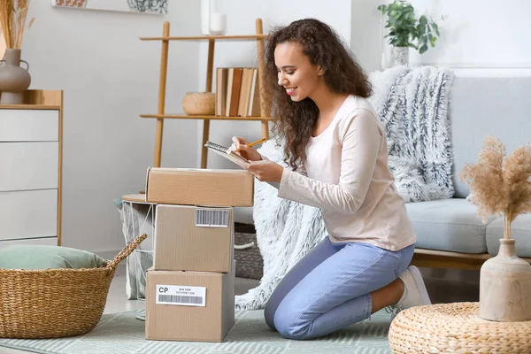 Young Woman Parcel Writing Notebook Home — Stock Photo, Image