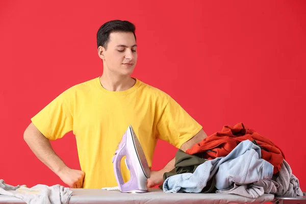 Handsome Young Man Iron Laundry Color Background — Stock Photo, Image