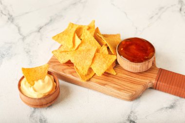 Hafif arka planda lezzetli nachos ve soslu pano