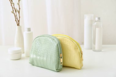 Odada dekoratif kozmetik ürünleri olan şık çantalar.