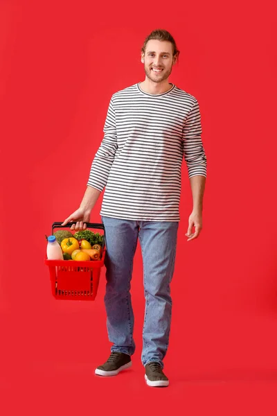 Young Man Shopping Basket Color Background — Stock Photo, Image
