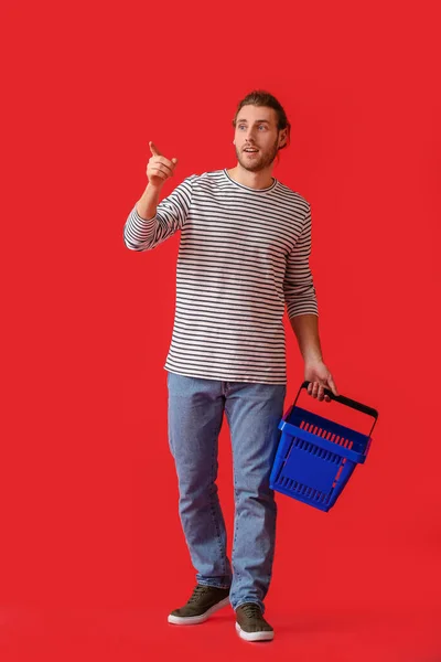 Young Man Empty Shopping Basket Color Background — Stock Photo, Image