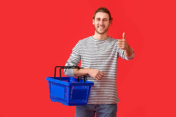 Young Man Empty Shopping Basket Showing Thumb Color Background — Stock Photo, Image