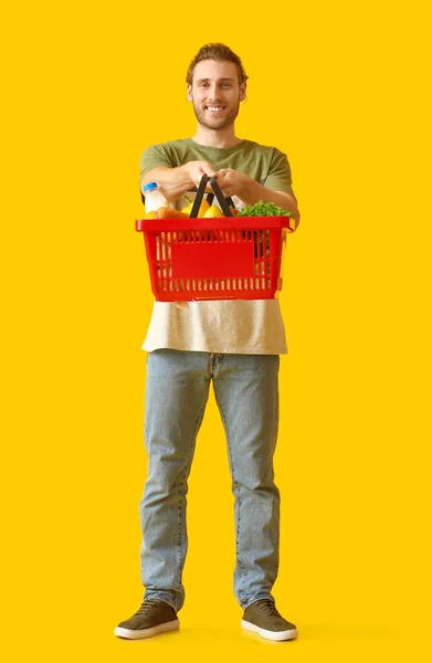 Young Man Shopping Basket Color Background — Stock Photo, Image