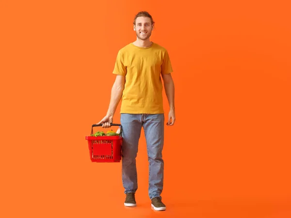 Young Man Shopping Basket Color Background — Stock Photo, Image