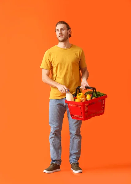 Young Man Shopping Basket Color Background — Stock Photo, Image