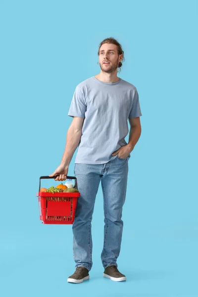 Young Man Shopping Basket Color Background — Stock Photo, Image