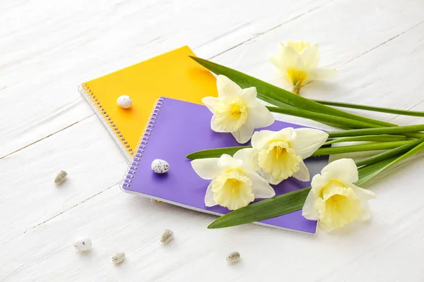 Beautiful Daffodils Notebooks Quail Eggs Light Wooden Background — Stock Photo, Image