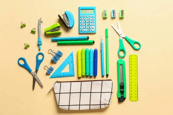 Pencil case and stationery on color background