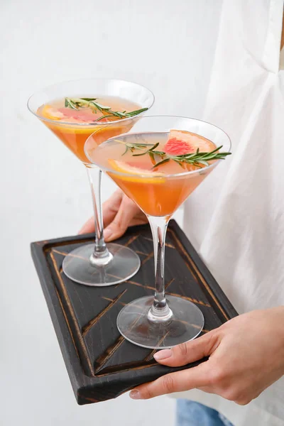 Woman Holding Board Glasses Tasty Grapefruit Cocktail Light Background Closeup — Stock Photo, Image