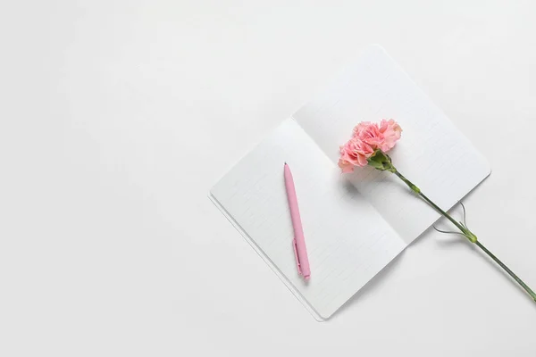 Beautiful Carnation Flower Pen Notebook Light Background — Stock Photo, Image