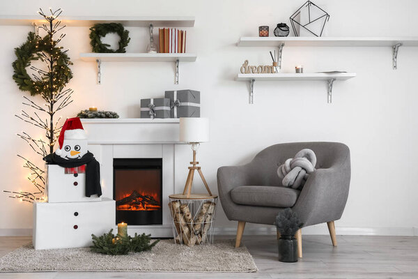 Interior of living room with fireplace and decorative snowman