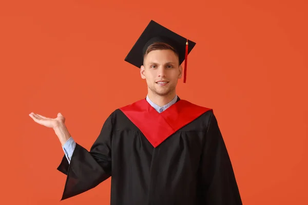 Male Graduating Student Showing Something Color Background — Stock Photo, Image