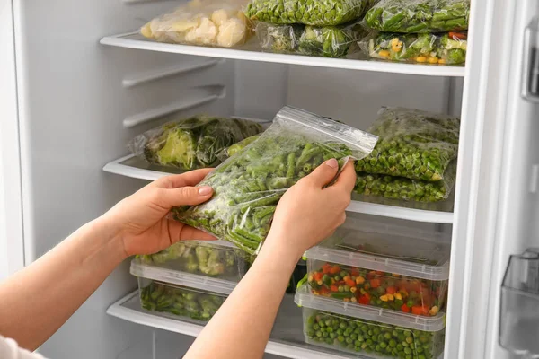 Woman Putting Plastic Bag Vegetables Refrigerator — Stock Photo, Image