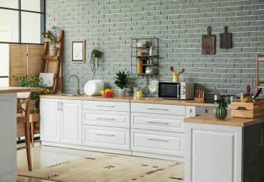 Modern mutfağın içinde mutfak aletleri ve ürünler var.