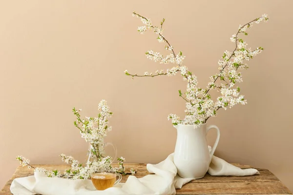 Cup Tasty Tea Jug Blooming Branches Wooden Table — Stock Photo, Image