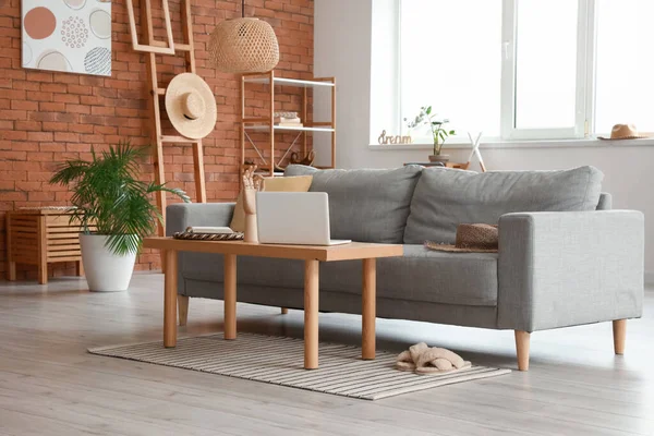 Stylish interior of living room with cozy sofa