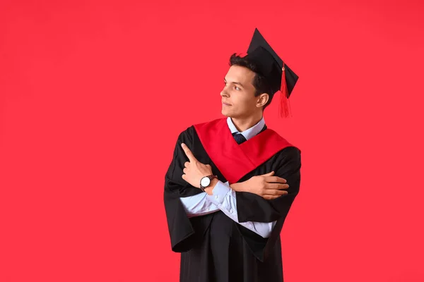 Male Graduating Student Pointing Something Color Background — Stock Photo, Image