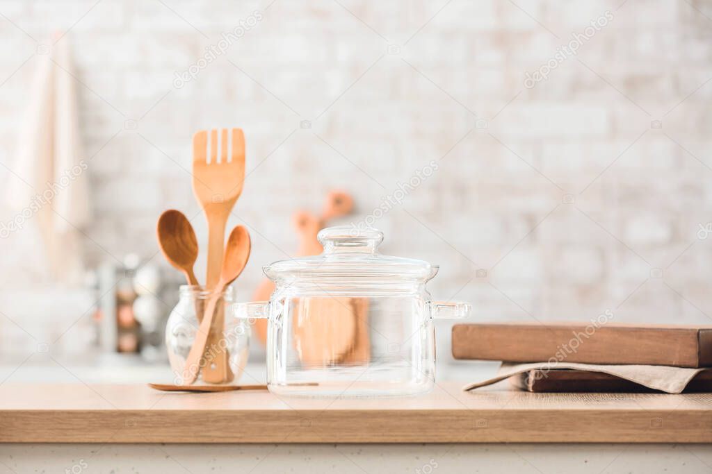 Stylish cooking pot on table in kitchen