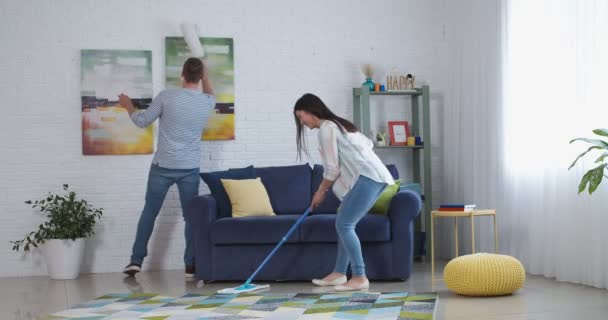 Happy Young Couple Having Fun While Doing Housework Room — Stock Video
